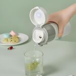A close-up view of six round white silicone leak stoppers, neatly arranged, designed for water bottle and tumbler lids.