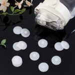 Close-up of a stack of 20 white, round silicone leak stoppers for water cups and bottles, showing their smooth texture.