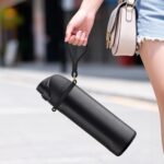 Very dark silicone handle strap securely attached to an Owala water bottle, showing its ergonomic design for carrying.